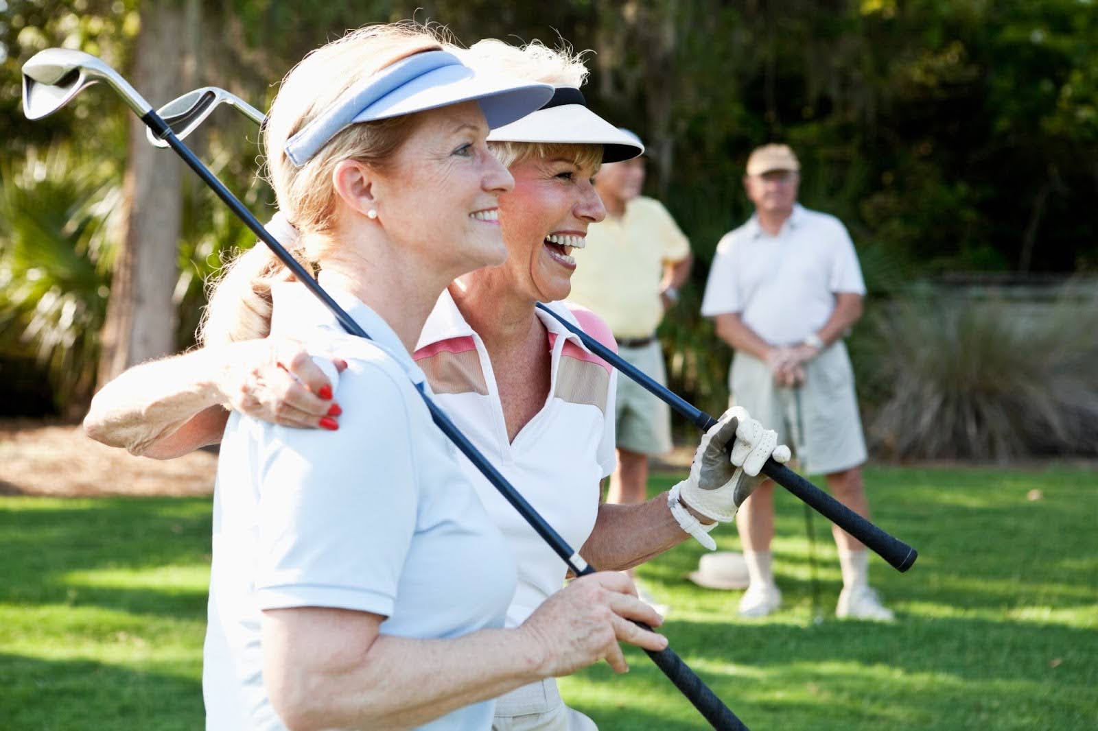 Two senior women on the golf course smiling