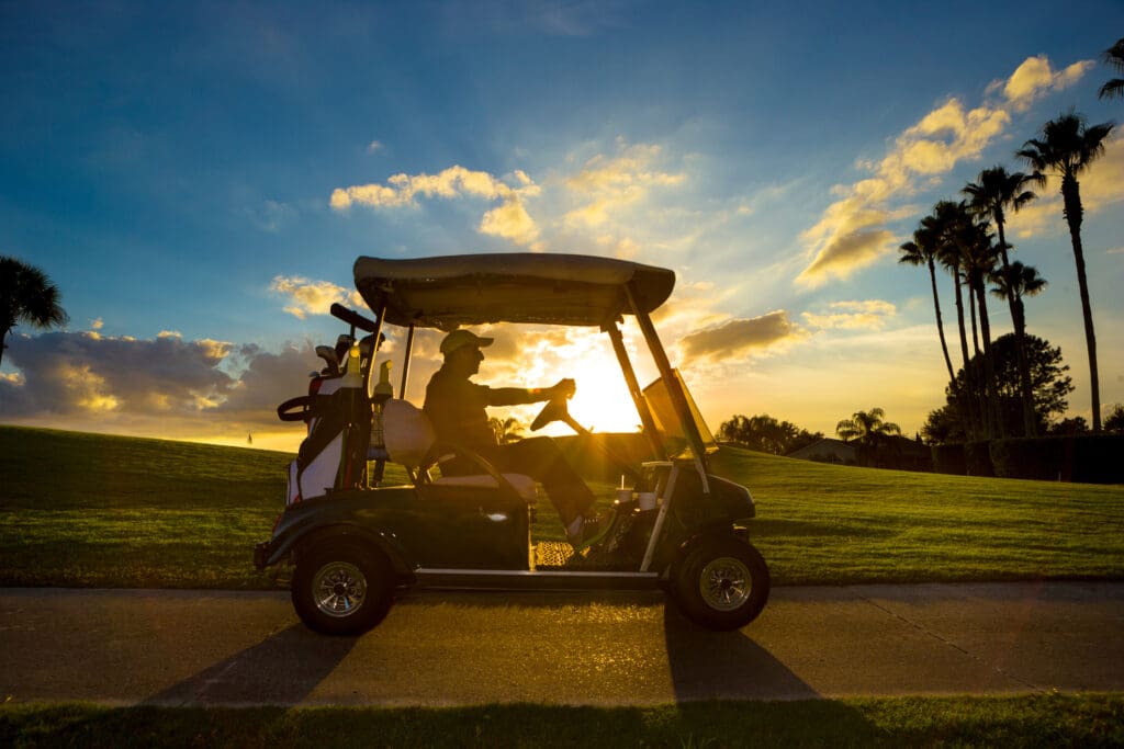 Senior man driving a golf cart
