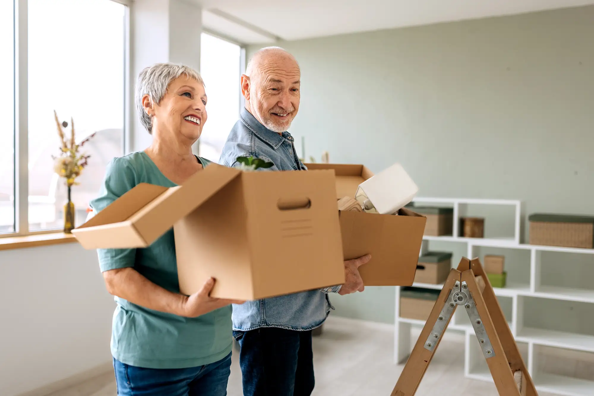 Happy seniors moving to their new independent living apartment home at The Arlington of Naples, a retirement community in Naples, FL.