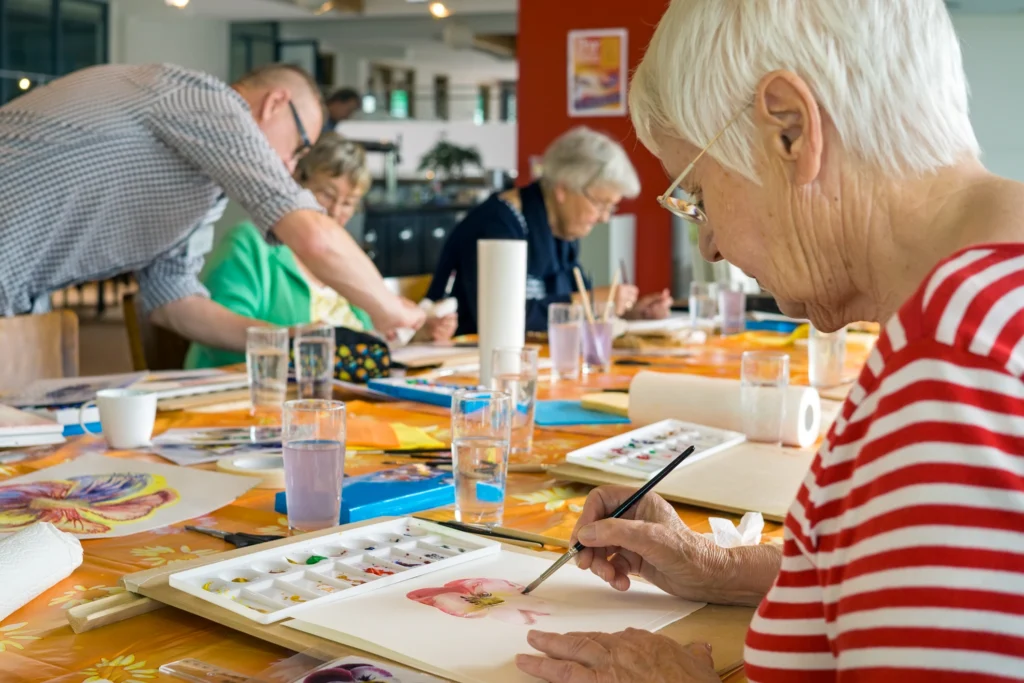 A senior class on water painting for seniors with memory loss at The Arlington Of Naples, a secure dementia care community in Naples, Florida.